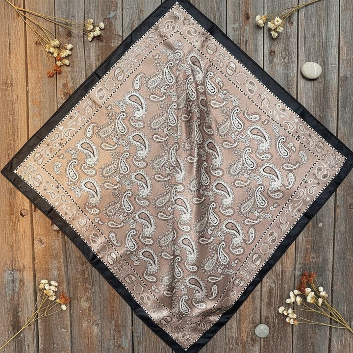 Black and tan paisley wild rag smooth lay flat display on rustic weathered wood